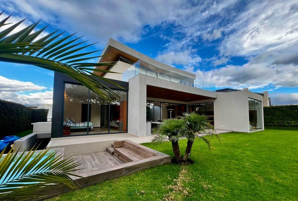 Fachada posterior de la Casa Sr. Raúl Ayala con jardín y piscina
